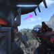 Master Chief surveys Zeta Halo from the Tower while holding a shock rifle in Halo Infinite.